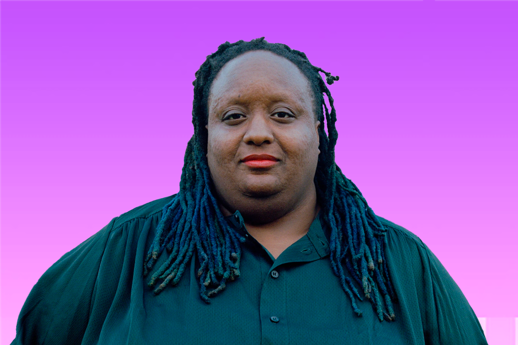 Imani headshot - black woman with braided hair in a green top