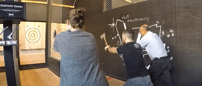 Deque employees throwing axes at a target