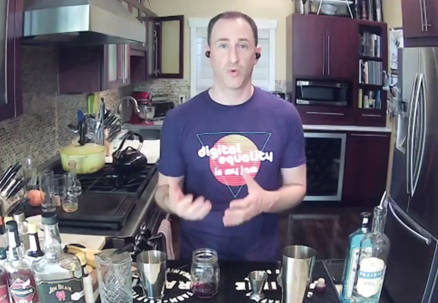 Jason in his kitchen, surrounded by various Spirits and drink ingredients