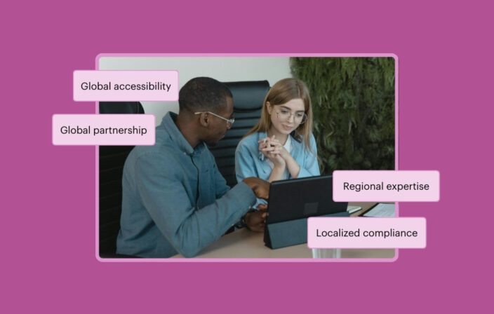 Two professionals collaborating on a laptop. The callout text reads Global accessibility, Global partnership, Regional expertise, and Localized compliance.