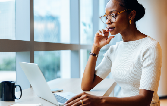 A woman at work on her laptop in a bright office
