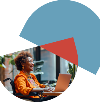 woman in wheelchair sitting at desk and smiling at laptop screen