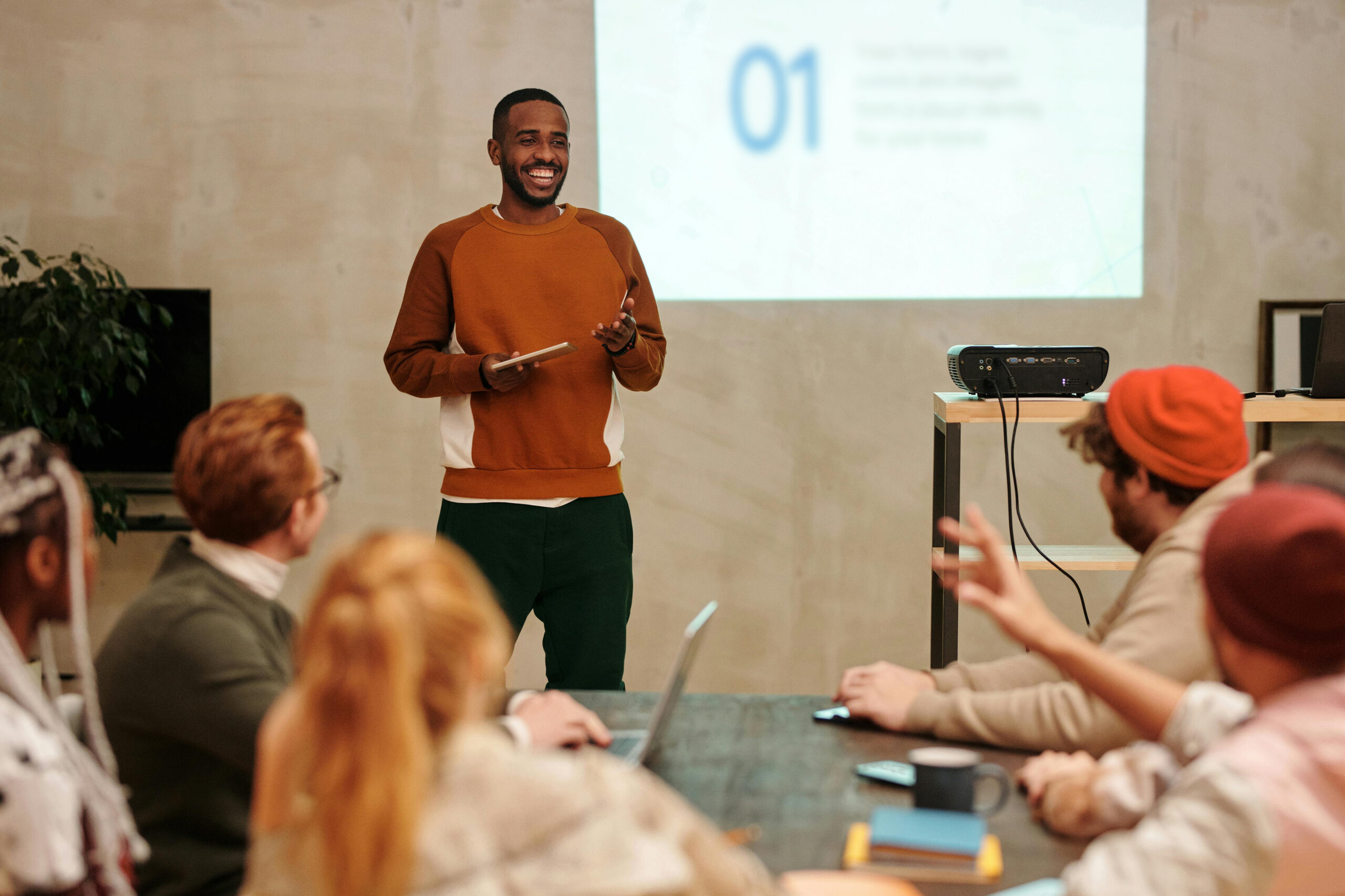 A team leader presenting in front of their colleagues.