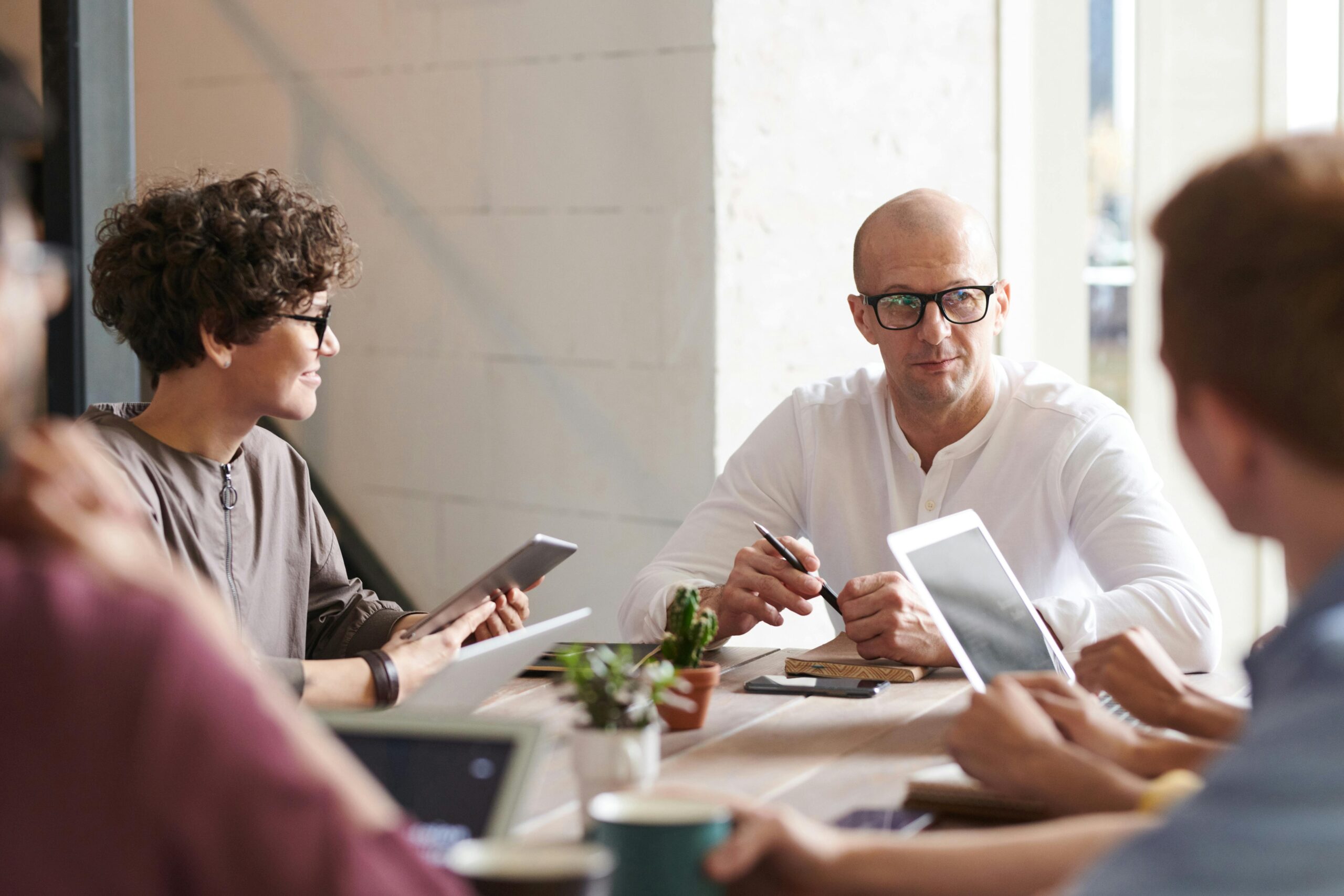 group of people talking at a conference table