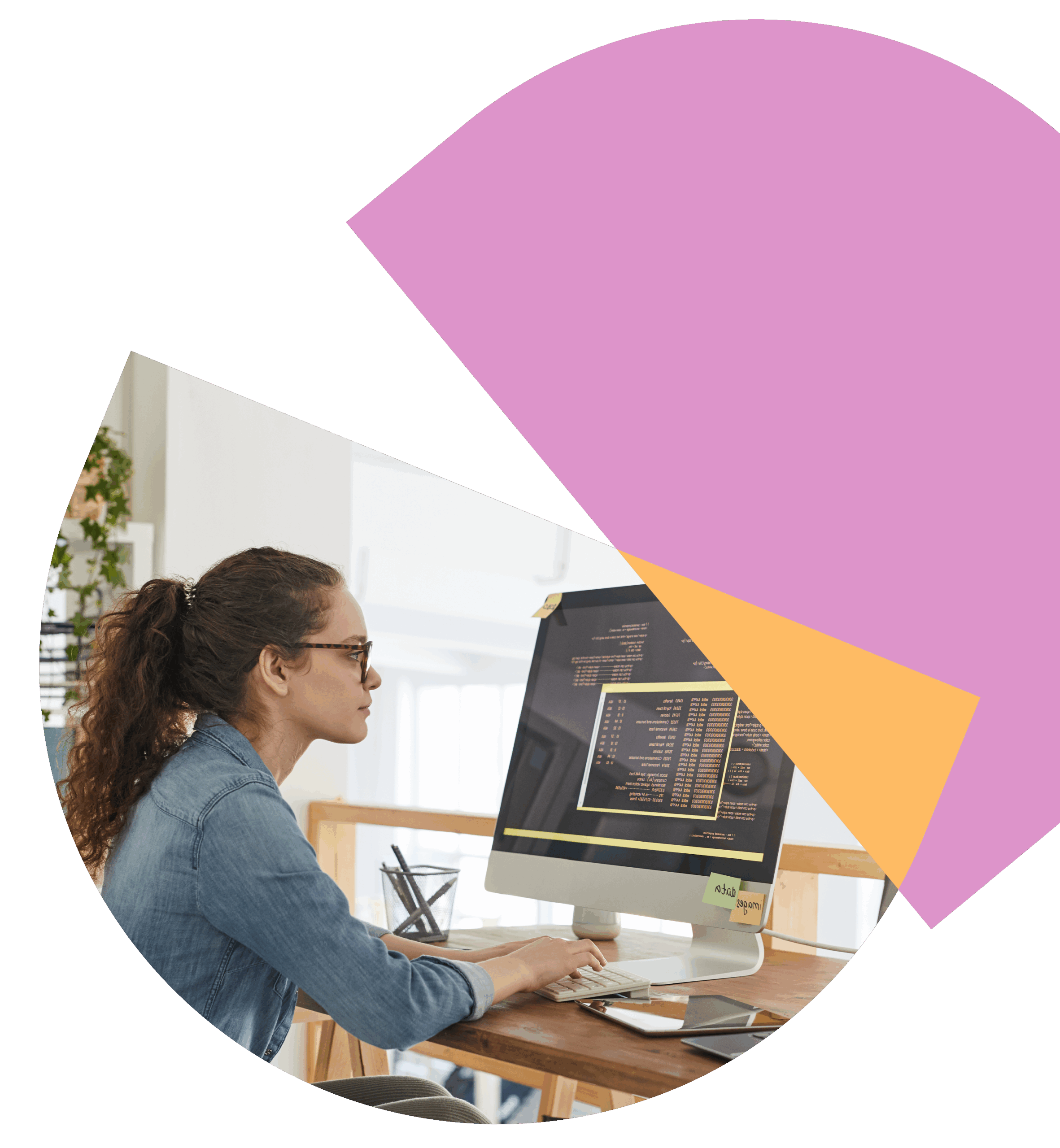 Woman with glasses working on code on a computer