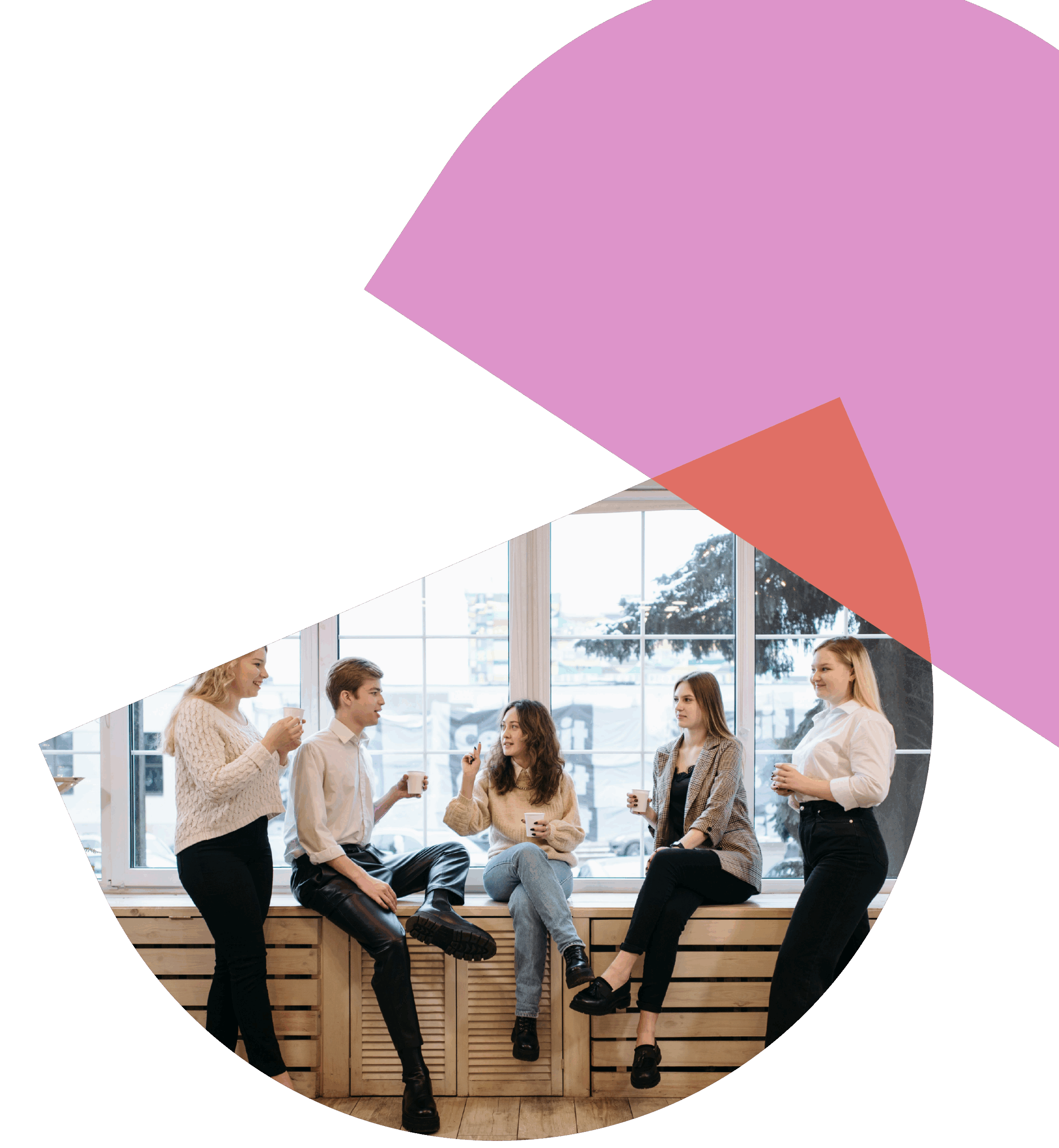 A group of professionals sitting and standing while chatting together.