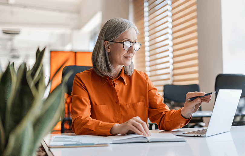 Image of a professional woman working at her laptop in an office.